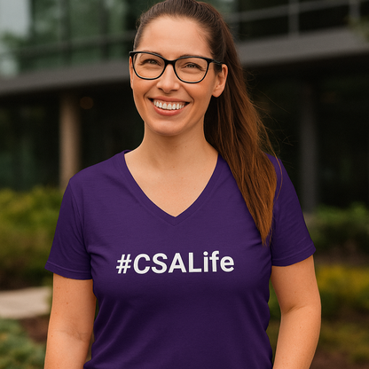 Woman wearing a purple '#CSALife' t-shirt outdoors.
