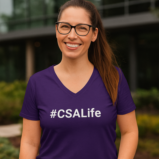 Woman wearing a purple '#CSALife' t-shirt outdoors.