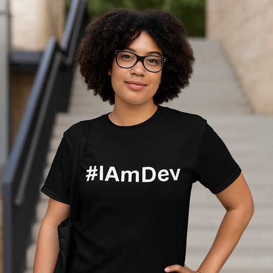 Person wearing a black t-shirt with '#IAmDev' text outdoors.