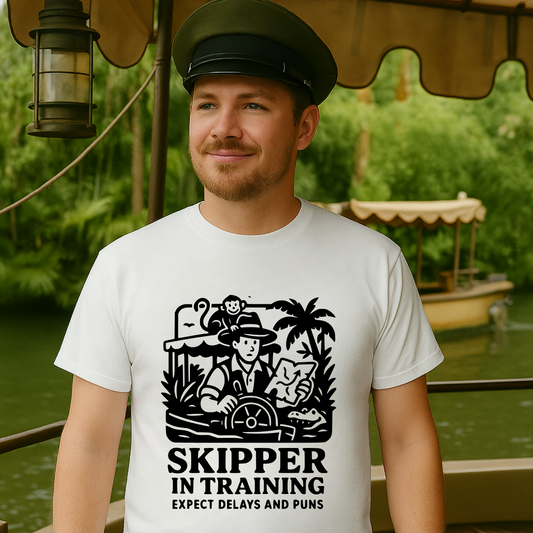 Man wearing a white t-shirt with a 'Skipper in Training' graphic and text, standing on a boat.